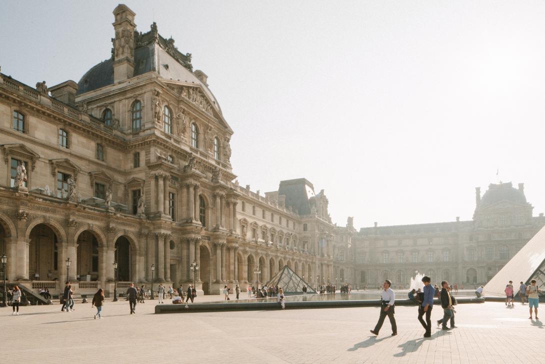 People walking near white building